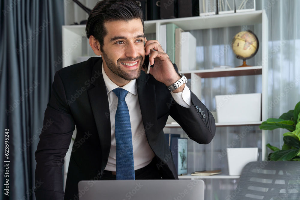 Poster diligent businessman busy talking on the phone call with clients while working with laptop in his of