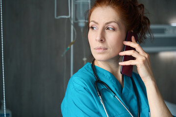 Female doctor talking on phone at clinic