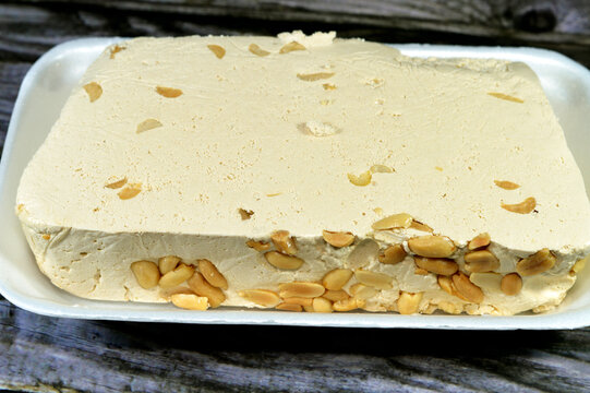 Traditional tahini halva with peanuts or Halawa Tahiniya, the primary ingredients in this confection are sesame butter or paste (tahini), and sugar, glucose or honey, it is basic tahini and sugar base