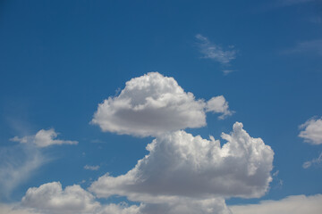 Cloudscapes, beautiful puffy white clouds in the sky above the Sonoran Desert, waiting on monsoon storms to develop. Gorgeous heaven like cloudy skies with intense blue color. Tucson, Arizona, USA.