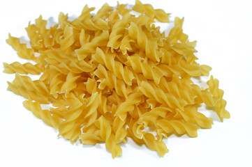 Pile of dry raw uncooked Macaroni, dry pasta shaped like fusilli, Made with durum wheat, selective...