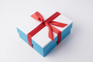 Obraz premium White and blue giftbox with red ribbon, white background. Generative AI