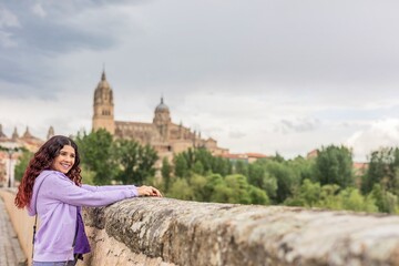 Latin mid Woman travel doing tourism in Salamanca Spain. Castile and leon cathedral, UNESCO architecture 