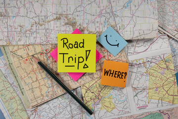 Lay flat background posted notes road trip hand written on notes with old road maps in the back