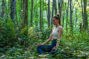 woman doing yoga in the forest