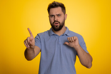 I am dont want it, not me. Confused young caucasian man pointing fingers hisself ask say who why me no thanks i do not need it, rejection, refusal, stop sign. Unhappy guy isolated on yellow background