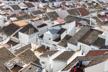 Aerial panoramic view of rooftops of white houses of Olvera town, considered the gate of white towns route in the province of Cadiz, Spain. - obrazy, fototapety, plakaty