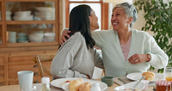 Hug, breakfast and women talking in a family home with food at table for health and wellness. A mother, people or friends together in dining room with love, care and conversation about relationship