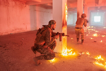  A group of professional soldiers bravely executes a dangerous rescue mission, surrounded by fire in a perilous building.