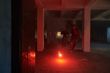  A group of professional soldiers bravely executes a dangerous rescue mission, surrounded by fire in a perilous building.