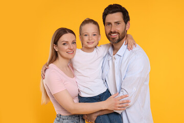 Portrait of happy family on orange background