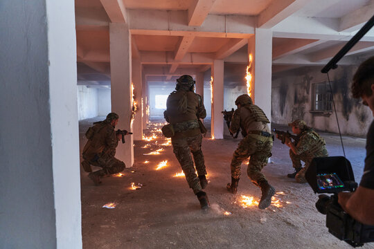 A professional cameraman captures the intense moments as a group of skilled soldiers embarks on a dangerous mission inside an abandoned building, their actions filled with suspense and bravery