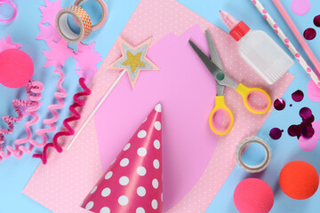 Flat lay composition with different materials to create party hats on light blue background....