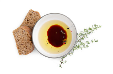Bowl of organic balsamic vinegar with oil, spices and bread isolated on white, top view