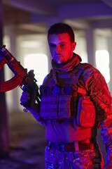 A professional soldier undertakes a perilous mission in an abandoned building illuminated by neon blue and purple lights