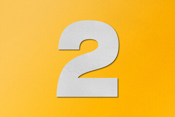 white paper type paper alphabet number 2 isolated on yellow background
