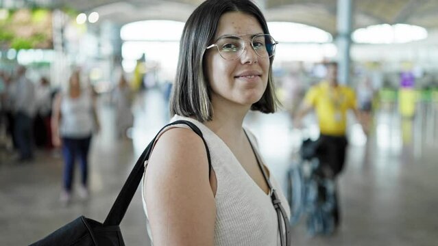 Young beautiful hispanic woman smiling at the airport