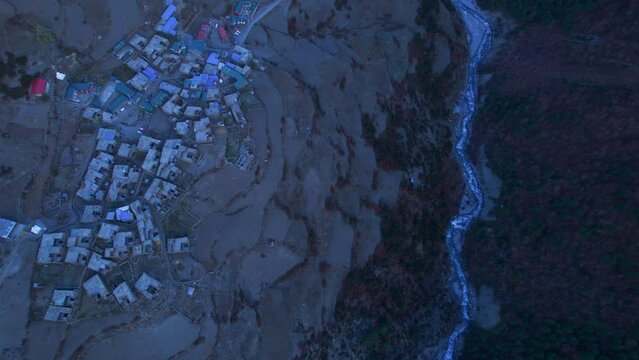 Aerial top down tilt up panoramic view valley with river stream and Khangshar village houses in Mamang district. Tilicho base camp trail. Himalayas mountains and trekking concept.