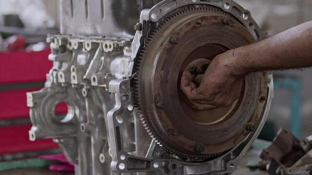 Repair and Replacement of Flywheel Gear of Car Engine in Repair Shop Footage.