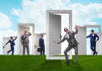 Businessman in uncertainty concept with many doors