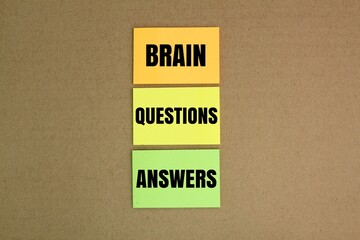 colored paper with the words Brain questions Answers. problem solving concept. faq concept