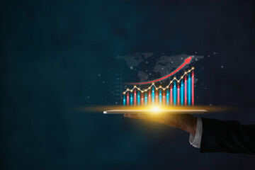 Businessman Hand Hold Tablet and Color Stock Market Graph and World Map in Dark Tone © steafpong