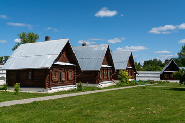 View of wooden residential buildings on the territory of the Holy Intercession Convent on a sunny summer day, Suzdal, Vladimir region, Russia