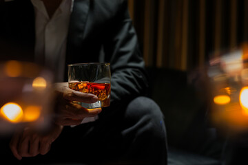 businessmen holding a glass of whiskey