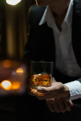 businessmen holding a glass of whiskey