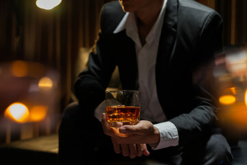 businessmen holding a glass of whiskey