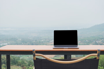 I sat at the top of the mountain, working on my laptop while admiring the beautiful view of the...