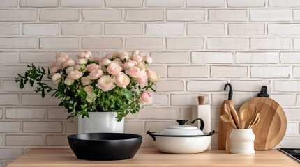 Closeup of kitchen interior. White brick wall, metro tiles, wooden countertops with kitchen utensils. Roses flowers in black sink. Modern scandinavian design. Home staging, cleaning concept.