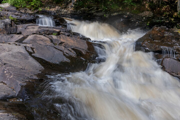 Stubb's Falls in Arrowhead Provincial Park near Huntsville, Ontario flows over some rocks through the forest, and marks the turnaround point of the hiking trail.