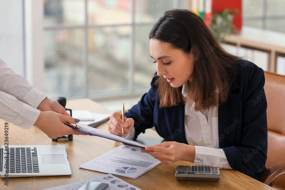 Poster Female accountant working with colleague at table in office