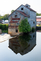 Fototapeta na wymiar Retired Historical Saw Mill Building by the River
