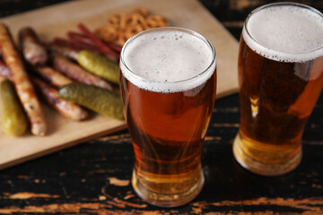 Glasses of cold beer on dark wooden background. Oktoberfest celebration