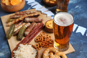Glass of cold beer on blue background. Oktoberfest celebration