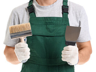 Male decorator with putty knife and brush on white background, closeup