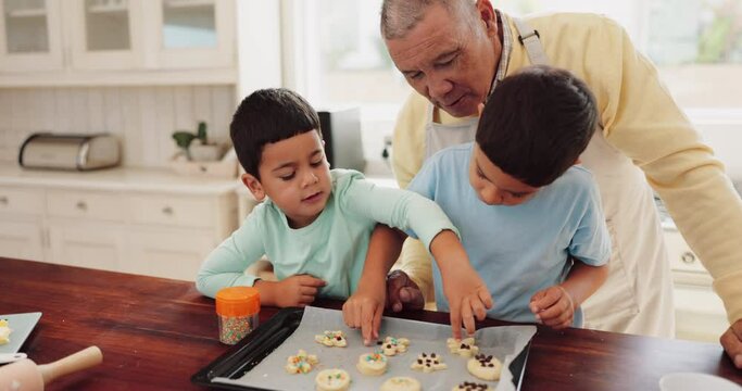 Baking, cookies and grandfather with kids in the kitchen making sweet treats, dessert or snack together. Equipment, ingredients and senior man teaching his grandchildren to make biscuits with recipe.