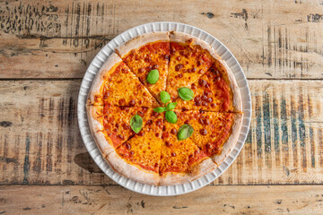 Delicious sliced pizza on wooden table, top view