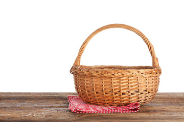 Fototapeta na wymiar Wicker picnic basket and napkin on wooden table against white background