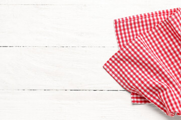 Fototapeta premium Red checkered napkin on light wooden background