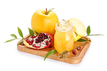 Wooden board with ripe apples, pomegranate, sweet honey and plant leaves on white background. Rosh hashanah (Jewish New Year) celebration