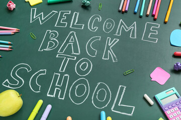 Different stationery with text WELCOME BACK TO SCHOOL on green chalkboard