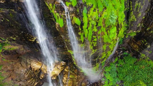 Tropical Diyaluma Falls in mountain jungle. Waterfall in the rainforest.