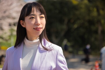A portrait of Japanese woman behind cherry blossom in Tokyo copyspace
