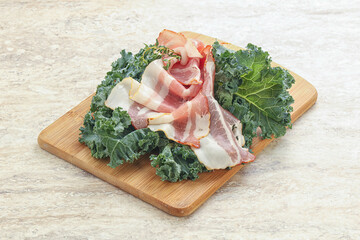 Raw pork bacon over board