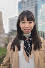 A portrait of Japanese woman behind cherry blossom 