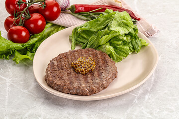Frilled beef burger cutlet with iceberg