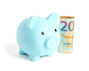 Blue piggy bank with euro banknotes isolated on white background
